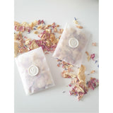 rose petal confetti packets with white wax seal