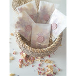 rose petal confetti packets with pink wax seal