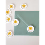 White and yellow flower wax seals