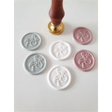 white, pink and blue stork wax seals